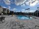 View of the large community pool with patio seating, green landscaping, and condo buildings at 3605 Conroy Rd # 535, Orlando, FL 32839