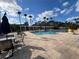 Relax by the community pool area featuring palm trees and pergola in a shared outdoor space at 3605 Conroy Rd # 535, Orlando, FL 32839