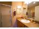 Bathroom featuring a frosted glass shower, large mirror and spacious vanity at 3780 Viscaya Ct, The Villages, FL 32163