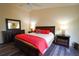 Large main bedroom showcasing a dark wood furniture set and ample lighting at 3780 Viscaya Ct, The Villages, FL 32163