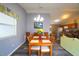 Bright dining area with a wooden table, seating for six, and an open view to the kitchen at 3780 Viscaya Ct, The Villages, FL 32163