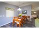 Dining area with hardwood floors, adjacent to the kitchen and open to the living room at 3780 Viscaya Ct, The Villages, FL 32163