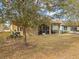 View of the backyard with a screened in patio, offering shade and protection from the elements at 3808 Serena Ln, Clermont, FL 34711