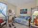 Spare bedroom featuring daybed with patterned covers, workout machine, and decor at 3808 Serena Ln, Clermont, FL 34711