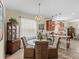 Open dining area with chandelier, seamlessly flowing into the kitchen at 3808 Serena Ln, Clermont, FL 34711