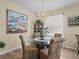 Elegant dining room with chandelier lighting and decorative artwork at 3808 Serena Ln, Clermont, FL 34711