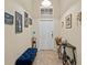 Bright entryway featuring tile flooring, neutral walls decorated with art, and a front door at the end at 3808 Serena Ln, Clermont, FL 34711