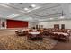 Large meeting room for events, featuring tables, chairs, and a stage with red curtains at 3808 Serena Ln, Clermont, FL 34711