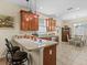 Eat-in kitchen featuring wood cabinets, pendant lights, stainless-steel dishwasher and tile flooring at 3808 Serena Ln, Clermont, FL 34711