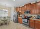 Cozy kitchen with stainless steel appliances and breakfast nook dining area at 3808 Serena Ln, Clermont, FL 34711