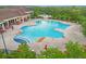 Aerial view of a large community pool with ample lounge seating and lush landscaping at 3808 Serena Ln, Clermont, FL 34711