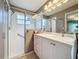 Bathroom featuring a glass shower door, updated vanity and modern countertops at 3847 Eversholt St, Clermont, FL 34711