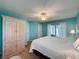 Bright bedroom featuring wood-look floors, closet and light turquoise colored walls at 3847 Eversholt St, Clermont, FL 34711