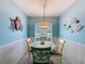 Dining room with decor, wainscotting, a modern light fixture and bright window at 3847 Eversholt St, Clermont, FL 34711