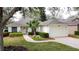 Inviting single-story home with lush landscaping, paver walkway, and two-car garage at 3847 Eversholt St, Clermont, FL 34711