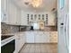 A kitchen with all-white cabinetry, appliances, and tiled floors at 3847 Eversholt St, Clermont, FL 34711