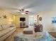 Cozy living room with wood floors, a ceiling fan, and a view of the entryway at 3847 Eversholt St, Clermont, FL 34711