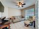 Cozy living room with a comfortable sofa, chair, tile flooring, and a bright window at 3847 Eversholt St, Clermont, FL 34711