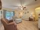 Relaxing living room featuring wood floors, a ceiling fan, and access to the backyard patio at 3847 Eversholt St, Clermont, FL 34711