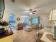 Comfortable living room featuring wood floors, ceiling fan, and sliding doors to outside space at 3847 Eversholt St, Clermont, FL 34711