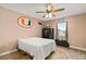 Comfortable bedroom with ceiling fan, natural light, and wood-look floors at 40707 E Ninth Ave, Umatilla, FL 32784