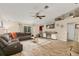 Cozy living room with wood-look floors, a ceiling fan, and a comfortable sofa at 40707 E Ninth Ave, Umatilla, FL 32784