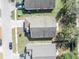 Overhead shot reveals the home's roof and landscaping in relation to the street and nearby greenery at 4078 Waltham Forest Dr, Tavares, FL 32778