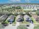 Bright aerial shot of a neighborhood home in a suburban community, surrounded by trees at 4078 Waltham Forest Dr, Tavares, FL 32778