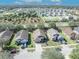 Aerial view of a residential neighborhood with tree-lined streets and well-kept lawns on a sunny day at 4078 Waltham Forest Dr, Tavares, FL 32778