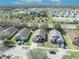 Aerial view of a residential neighborhood featuring well-maintained homes and green spaces on a sunny day at 4078 Waltham Forest Dr, Tavares, FL 32778