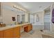 Bright bathroom featuring double sinks, a soaking tub, and a separate shower at 4078 Waltham Forest Dr, Tavares, FL 32778