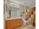 A well-lit bathroom featuring neutral tones, a single sink, and a shower with a curtain at 4078 Waltham Forest Dr, Tavares, FL 32778