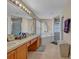 Bright bathroom featuring double sinks, a soaking tub, and a separate shower at 4078 Waltham Forest Dr, Tavares, FL 32778