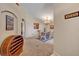 Open-concept dining area with chandelier lighting and adjacent hallway and entryway at 4078 Waltham Forest Dr, Tavares, FL 32778