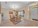 Cozy dining space with a glass-topped table, adjacent to a bright window and entryway at 4078 Waltham Forest Dr, Tavares, FL 32778