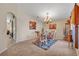 Dining room with a glass-topped table and upholstered chairs, set on a decorative area rug at 4078 Waltham Forest Dr, Tavares, FL 32778