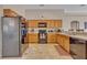 Well-equipped kitchen featuring wooden cabinets, black appliances, and a functional layout at 4078 Waltham Forest Dr, Tavares, FL 32778