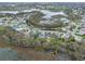 Lovely aerial view of a community surrounding a beautiful pond at 4609 Inverness Dr, Leesburg, FL 34748