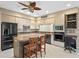 Eat-in kitchen featuring modern appliances, tile flooring and an island with seating at 4609 Inverness Dr, Leesburg, FL 34748