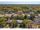 Aerial view of home with a private pool surrounded by lush greenery in a residential neighborhood at 4830 Tellson Pl, Orlando, FL 32812