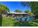 This backyard showcases a beautiful pool area with lots of greenery and an outdoor seating area at 4830 Tellson Pl, Orlando, FL 32812