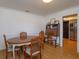 Dining room features a wood table, chairs, and view into the kitchen at 4830 Tellson Pl, Orlando, FL 32812