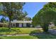 Single-story home boasting a green lawn and mature trees enhancing its curb appeal at 4830 Tellson Pl, Orlando, FL 32812