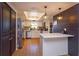 Well-lit kitchen featuring updated appliances, ample counter space, and modern pendant lighting at 4830 Tellson Pl, Orlando, FL 32812