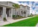 Townhouse exterior with landscaped front yard, sidewalk, and street view at 4903 Windermere Ave, Kissimmee, FL 34746