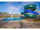 Large, blue and green waterslide, and a pool create a dynamic and fun recreational space at 4903 Windermere Ave, Kissimmee, FL 34746