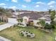 Aerial view of a well-maintained single-story home with lush landscaping and a charming front yard at 4955 Ne 124Th Rd, Oxford, FL 34484