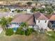 Aerial view of a backyard featuring a screened-in pool, tropical landscaping, and a well-maintained lawn at 4955 Ne 124Th Rd, Oxford, FL 34484