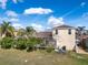 A backyard with tropical plants and a screened-in pool area offers a private and relaxing outdoor space at 4955 Ne 124Th Rd, Oxford, FL 34484