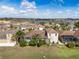 View of a backyard with a covered pool, and partial view of a house and surrounding neighborhood at 4955 Ne 124Th Rd, Oxford, FL 34484